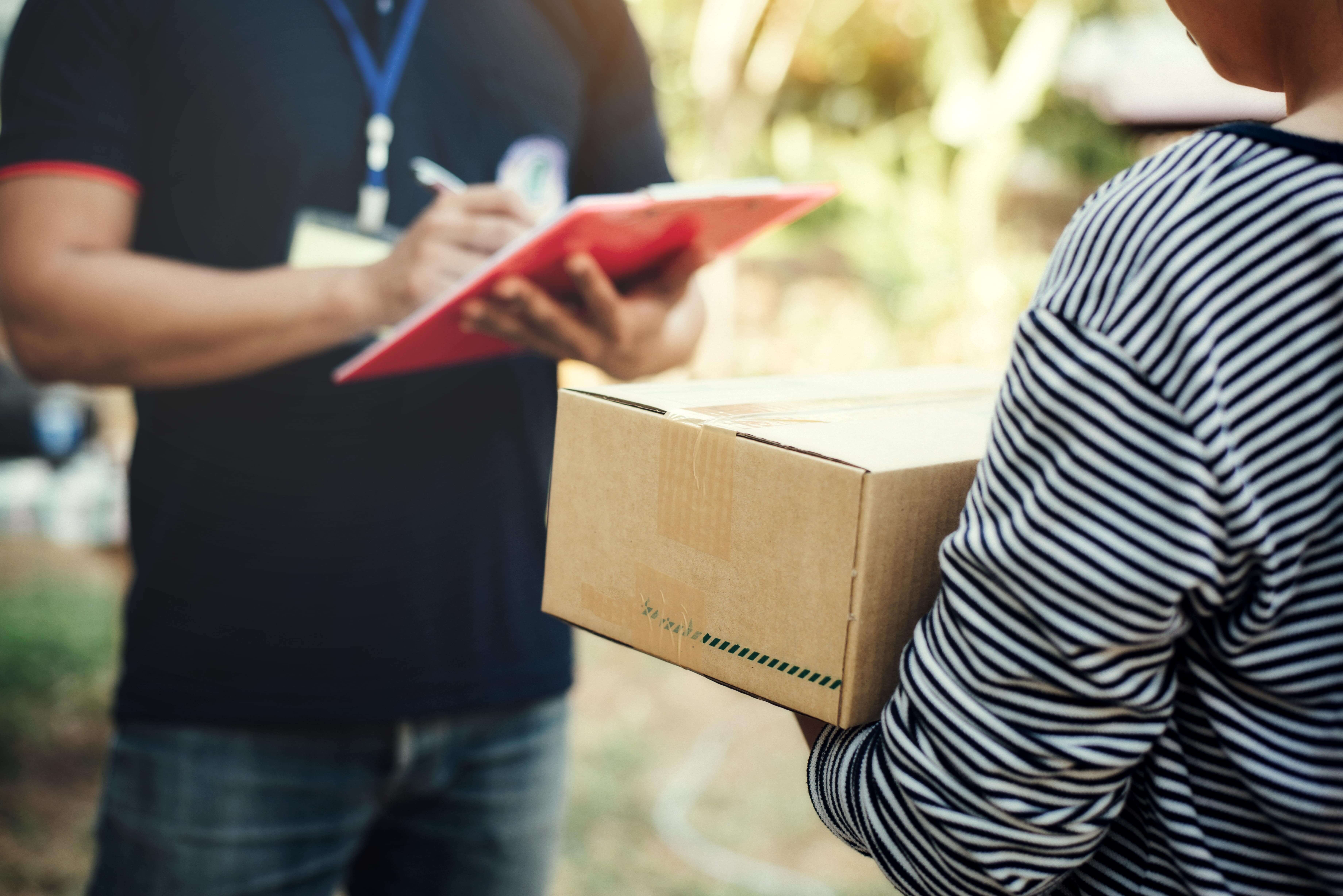 close up woman holding box with service delivery holding board min