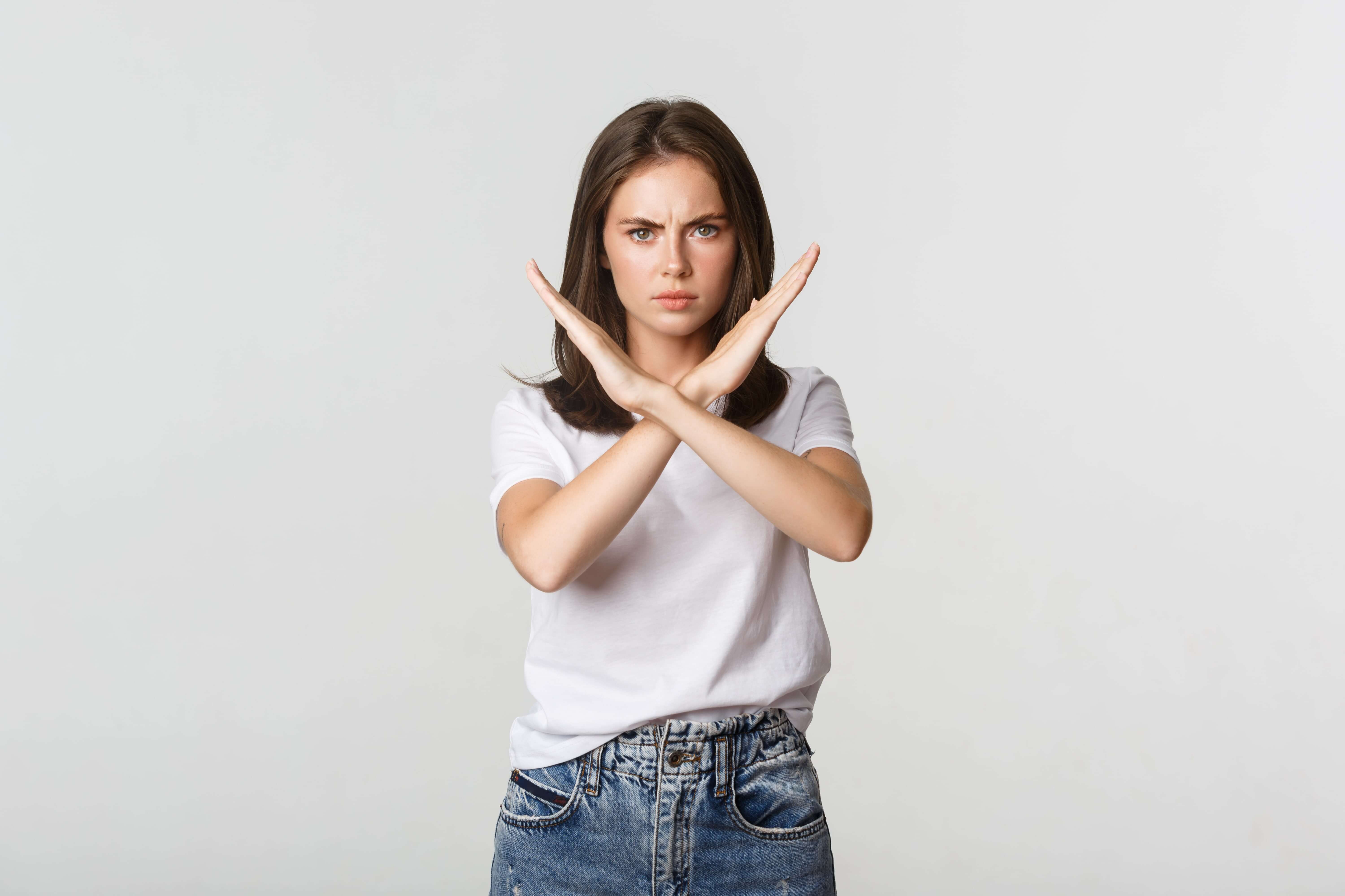 serious angry woman showing cross stop something bad express disapproval dislike min